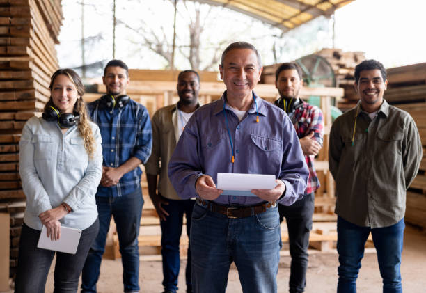 istock Happy group of employees working at a lumberyard 1755073608