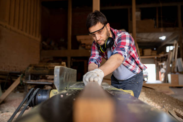 istock Worker cutting wood with a saw at a lumberyard 1755074206