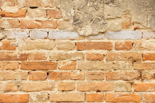 istock red brick grunge weathered wall facade in Zadar Croatia 175507548