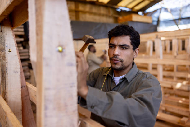 istock Carpenter hammering a nail while working at a wood factory 1755075882