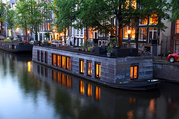 Glowing Houseboat A glowing houseboat in an Amsterdam canal. houseboat photos stock pictures, royalty-free photos & images