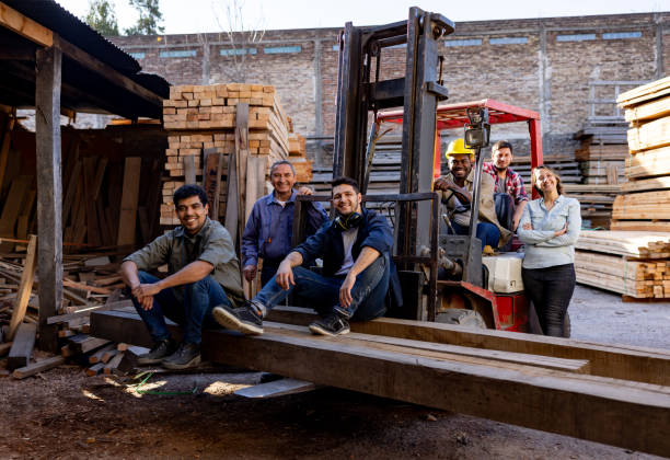 istock Group of employees working at a lumberyard and smiling 1755077009