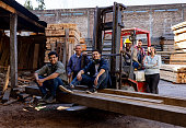 Group of employees working at a lumberyard and smiling
