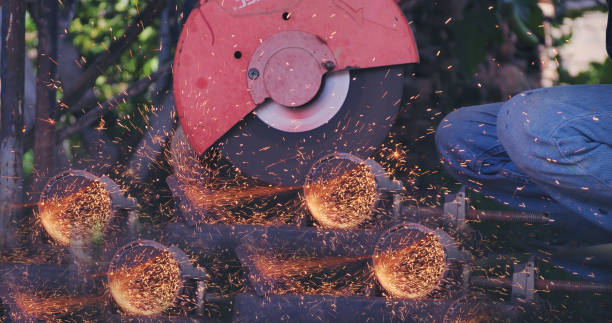 istock Hot flame welding metal work cutting fire iron workshop. Welding machine iron metal sparking. Locksmith using Welding machine cutting metal processing grinder. Close up hands Sparks in metalworking 1755084474