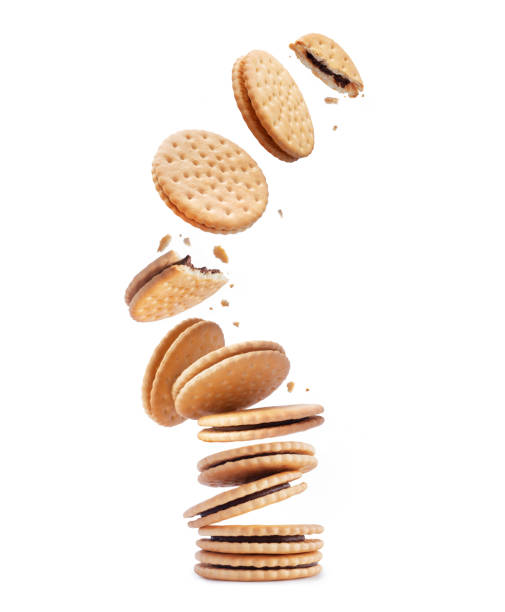 istock Crispy cookies with chocolate filling are falling isolated on a white background 1755085633