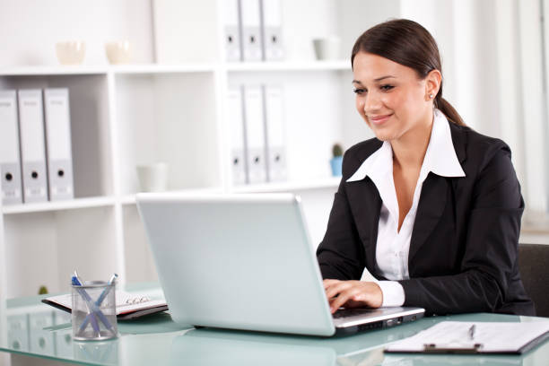 istock Smiling successful businesswoman working on laptop 175509065