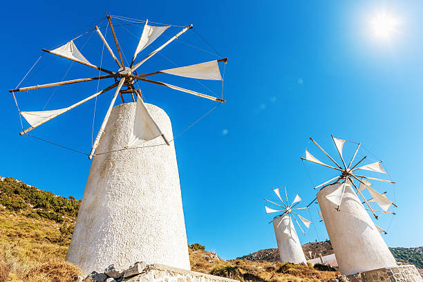 Crete Windmills Greece Windmills upon a hill against light blue summer sky. crete photos stock pictures, royalty-free photos & images