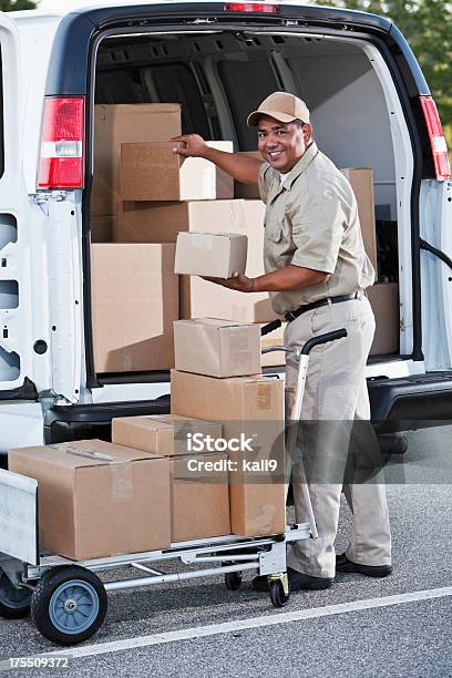 Hispanic Man Delivering Packages Stock Photo - Download Image Now - Box - Container, Hand Truck, Unloading
