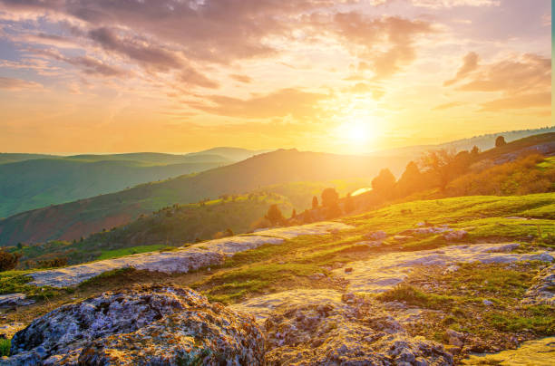 istock Foggy sunset or dawn in the mountains covered with grass and cloudy dramatic sky. 1755099464