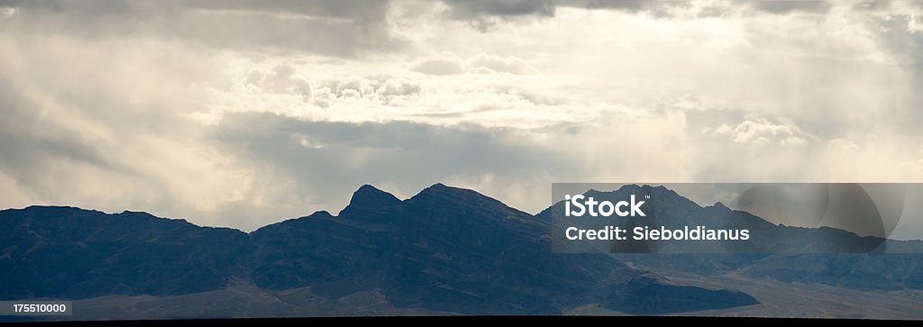 Rain in the Desert with backlit hills (Nevada). Back Lit Stock Photo