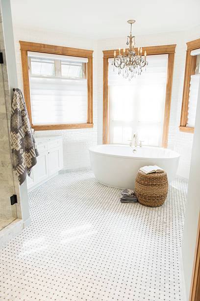 istock Large white bathroom with stand alone tub and chandelier 175510103