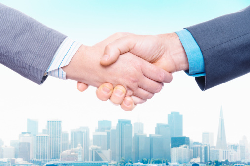 Two businessmen shaking hands, close-up