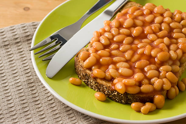 Baked Beans on Toast Close-up Baked Beans on Toast Close-up. Main focus toward the centre of the image softer focus at the edges. Beans on Toast stock pictures, royalty-free photos & images