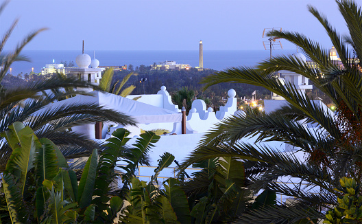 Resort in Playa del Ingles in Gran Canaria (Canary Islands). In the background the lighthouse faro de Maspalomas.