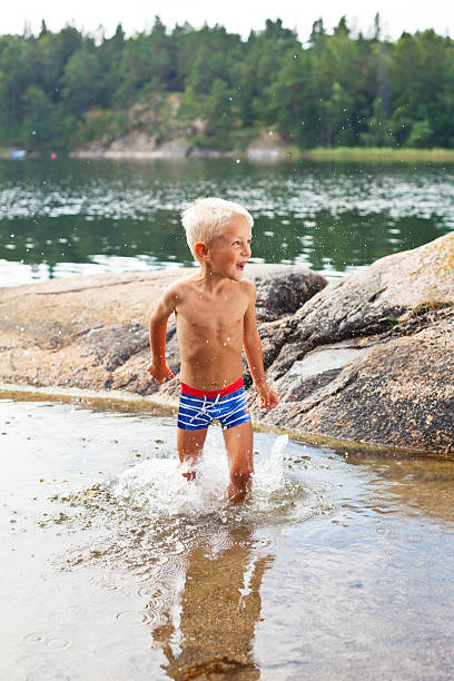 istock Little blond boy playing in the sea. 175512055