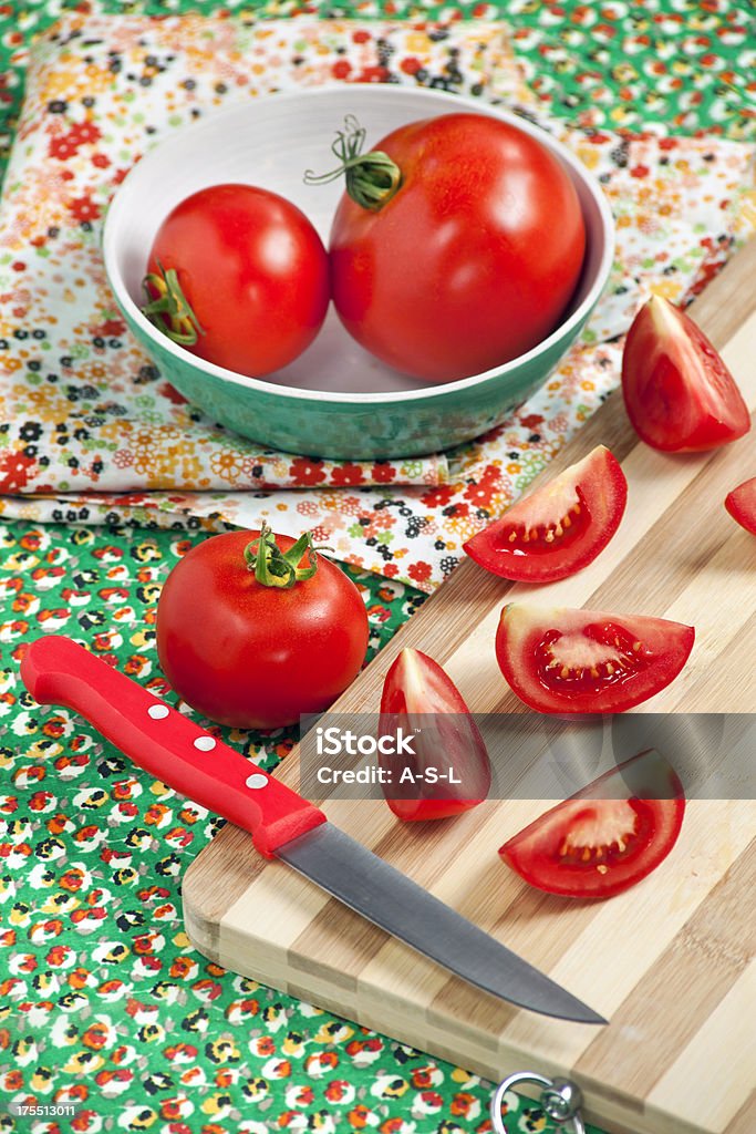 Sliced tomatoes Sliced tomatoes with kitchen knife on cutting board Bowl Stock Photo