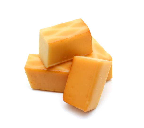 istock Cubes of cheddar cheese isolated on white 1755133271