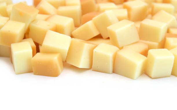 istock Cubes of cheddar cheese isolated on white 1755133932