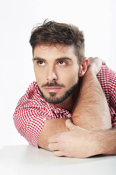 Handsome man portrait sitting hand on shoulder looking up