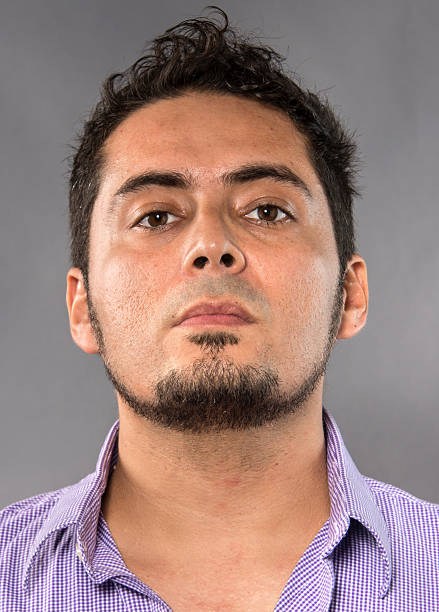 Hispanic man headshot Hispanic man mug shot on gray background mediterranean ethnicity stock pictures, royalty-free photos & images