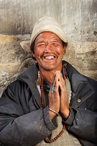 istock Tibetan man praying with rosary. 175514460
