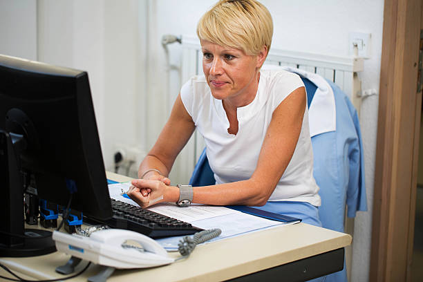 istock Nurse in her office,her daily paper work... 175514480