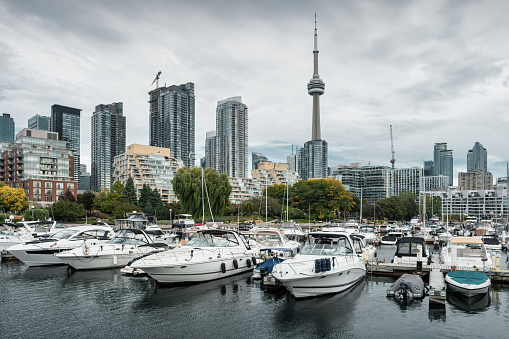 Boats are docked at the Harbourfront marina in downtown Toronto, Ontario, Canada on a cloudy day.