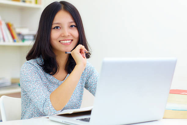 istock happy young woman using computer in home 175515336
