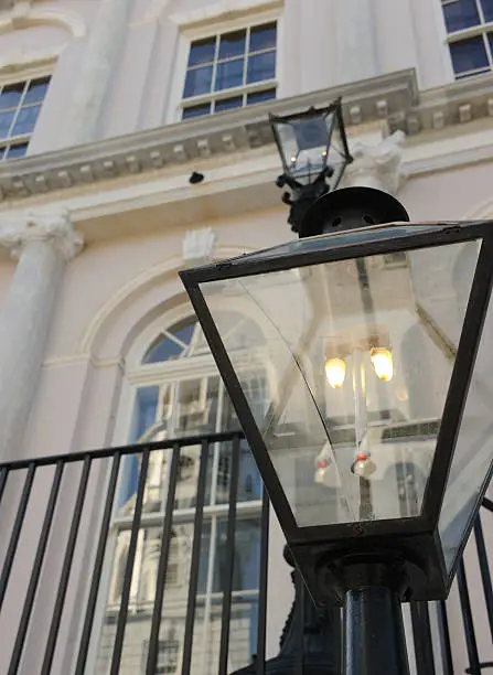 "Gaslight at the front of City Hall, Broad Street, South Carolina, USA, with reflection of St Michael's Church in one of the windows."