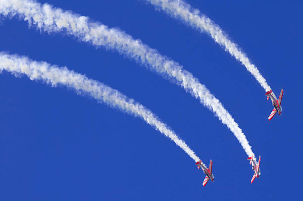 Three airplanes during an airshow Three airplanes during an airshow stunt airplane airshow air vehicle stock pictures, royalty-free photos & images