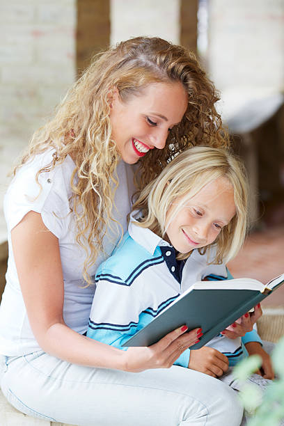 istock Woman reading book to little boy 175515983