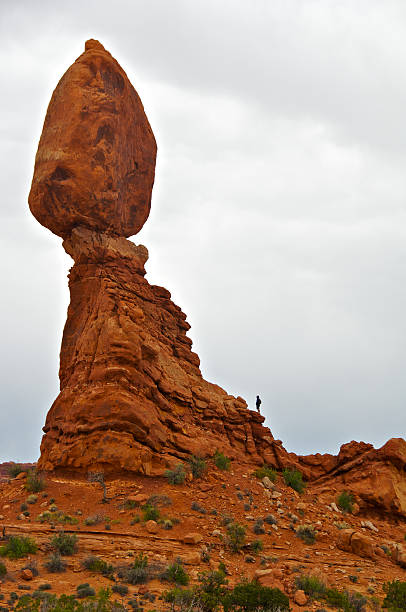 istock Man, dark sky, Balanced Rock, Arches National Park, Utah, USA 175516903