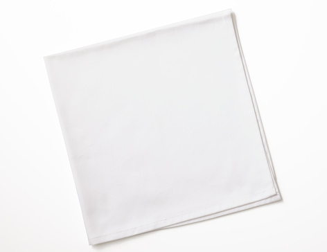 Isolated shot of folded white napkin on white background