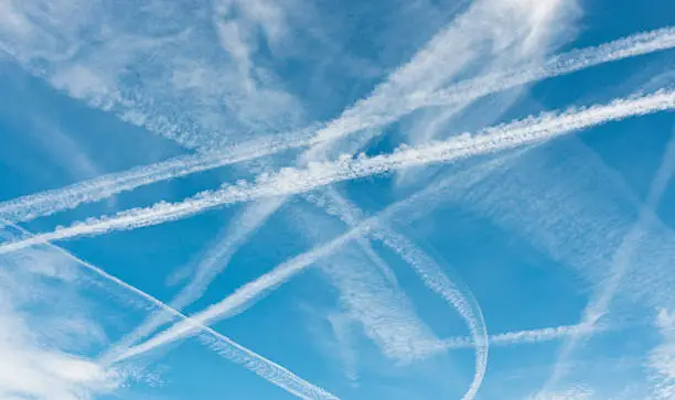 "Condensation trails, naturally created by aircraft engines..  Sometimes referred to as Chemtrails by conspiracy theorists."