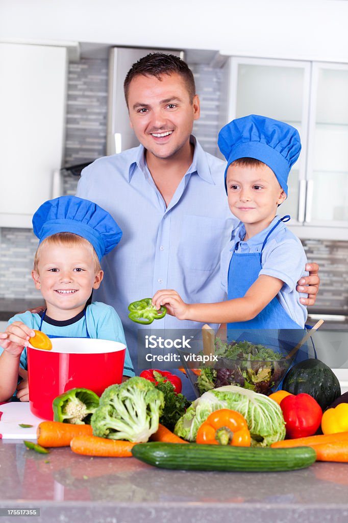 Padre con sus hijos en la cocina para la cena. - Foto de stock de 4-5 años libre de derechos