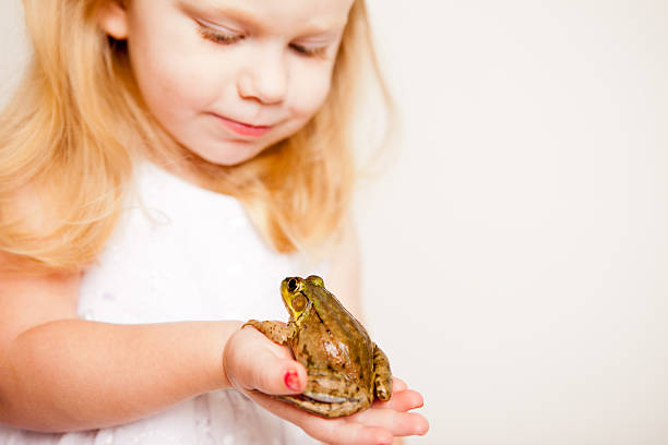 istock Happy Little Blond Princess Holding a Frog, With Copy Space 175518687
