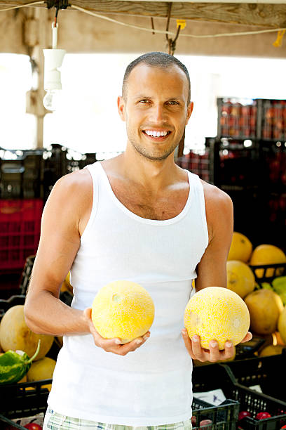 istock man holding cantaloupe 175518874