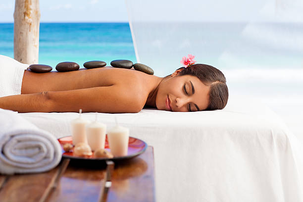 istock Woman enjoying a massage by the beach 175519018