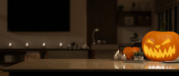 istock Workspace in Halloween theme, A copy space on a tabletop with a scary pumpkin lamp in a dark room. 1755191399