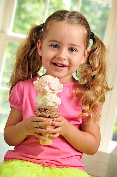 istock Cute Young Girl Eating a Triple Decker Ice Cream Cone 175519285