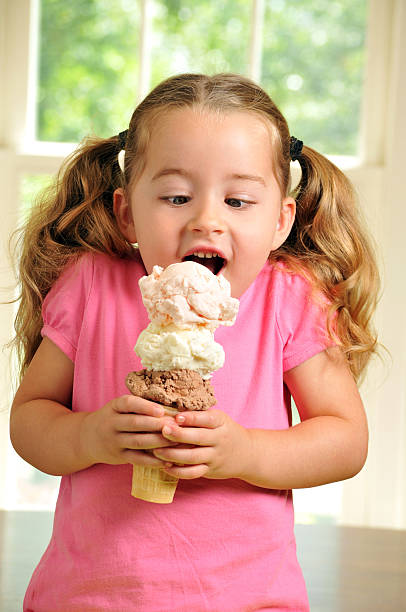 istock Cute Young Girl Eating a Triple Decker Ice Cream Cone 175519295