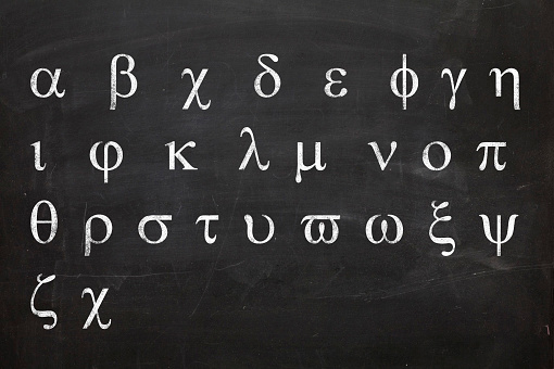 Greek alphabet written on blackboard in white chalk
