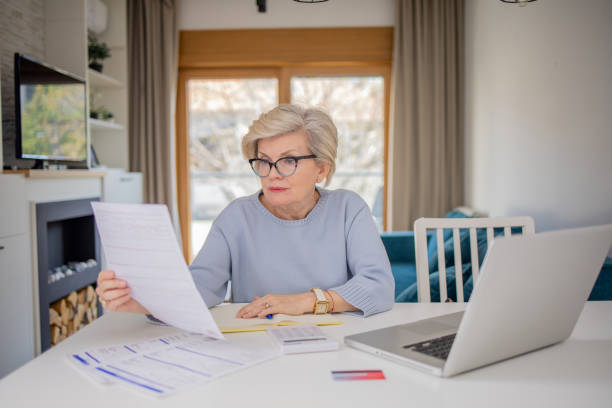 istock Senior woman going through paperwork 1755195226