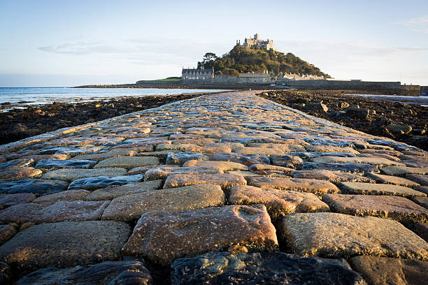 St Michaels mount Cornwall Low angle view of the stone block path leading to St Michaels mount Cornwall in late evening light. marazion photos stock pictures, royalty-free photos & images
