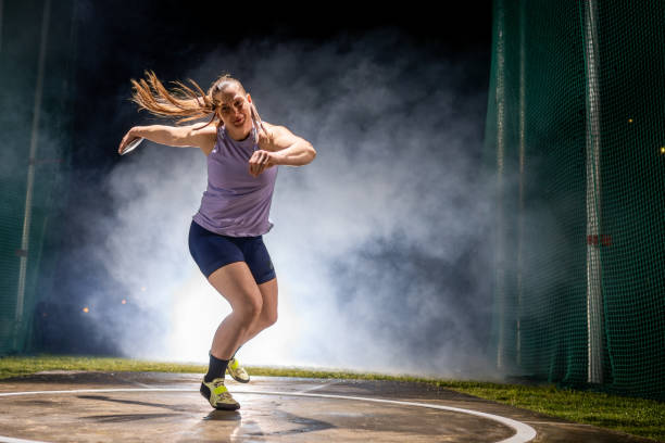 istock Female track and field athlete throwing discus portrait 1755196977