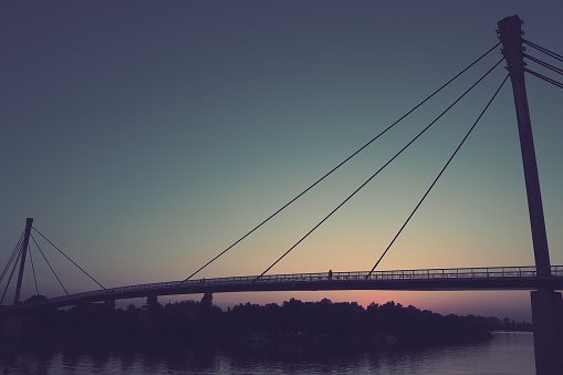 Pedestrian Bridge of the Saint Irinej over Sava river. Longest Pedestrian-Cycling Bridge in Europe Located Between Sremska Mitrovica and Macvanska Mitrovica. Twin towns on the opposite coasts. Sunset