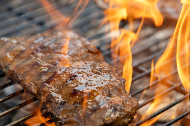 istock Piece of pork roasting on a charcoal barbecue grill 1755200428