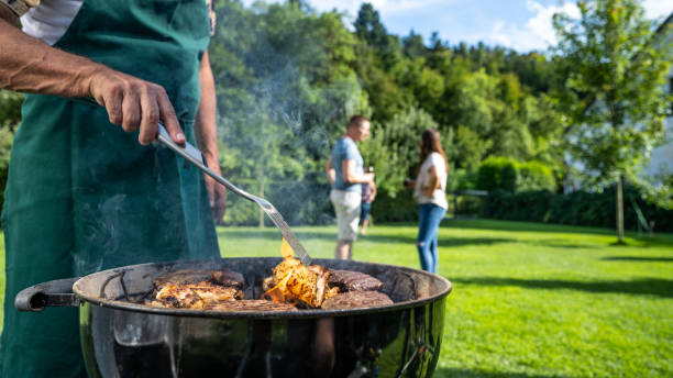 istock Man roasting meat on an outdoor grill 1755200451