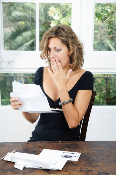 istock Woman in shock opening a letter 175520150