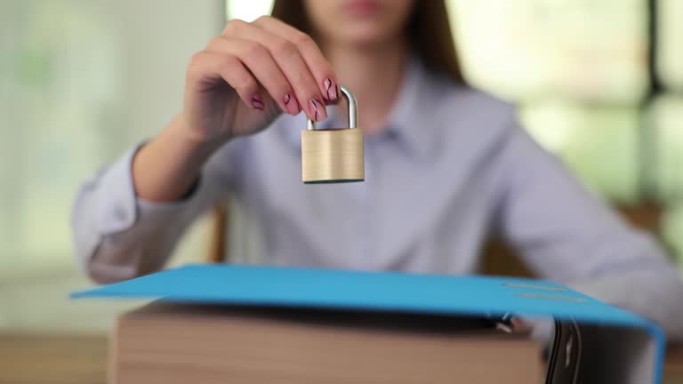 Files and documents with lock on wooden table